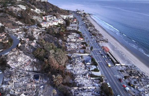 An aerial view shows the extent of the Palisades Fire on homes along the beach on Jan. 15 in Malibu.