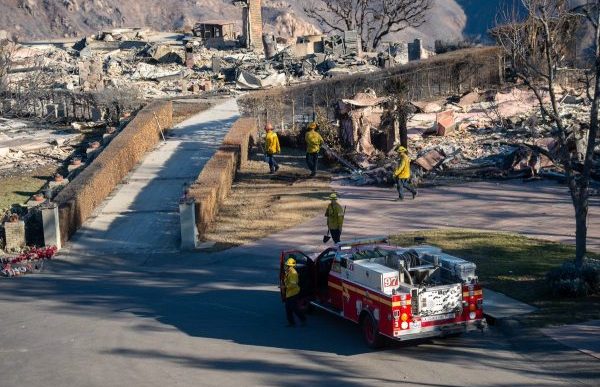 Firefighters do mop-up work amid the devastation caused by the Eaton Fire.