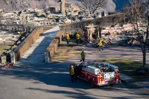 Firefighters do mop-up work amid the devastation caused by the Eaton Fire.