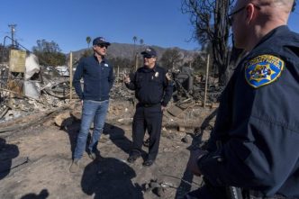 Gov. Gavin Newsom, at left, tours fire destruction in LA County with local first responders.