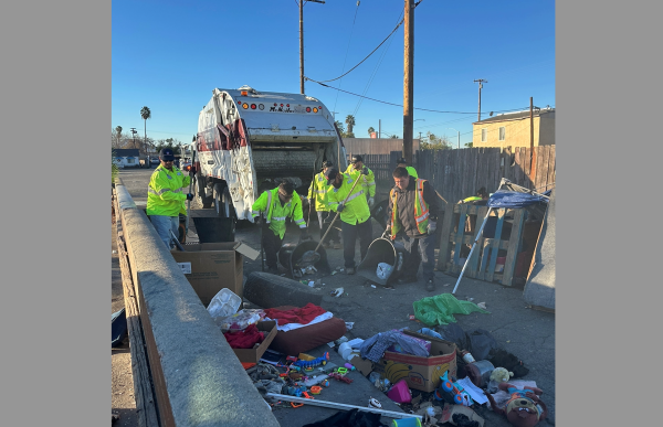 A crew clears an encampment from an alley near Baseline and D streets.