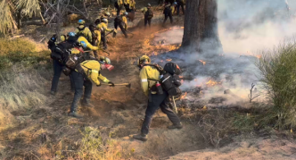 A crew suppresses flames from the Eaton Fire.