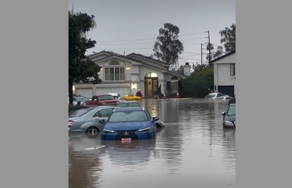 Cars sit in high water Friday in a Long Beach neighborhood after a water main broke.