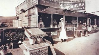 Lionel Sternberger is said to have invented the cheeseburger in the mid-1920s at this roadside snack stand on Colorado Boulevard in Pasadena. Pictured is Lionel's father, Herman Sternberger. The stand was later rebuilt as a restaurant named the Rite Spot. The photograph was displayed in at least one restaurant later operated by the family and appears to have been labeled to reflect the franchise name.