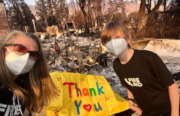 Kelsey Brown and her son Calder thank first responders in front of the remains of their Altadena home.